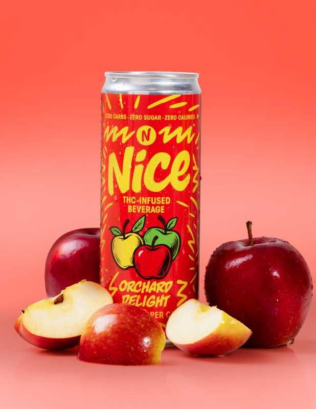 Red NICE Orchard Delight can on a coral background with whole and sliced red apples